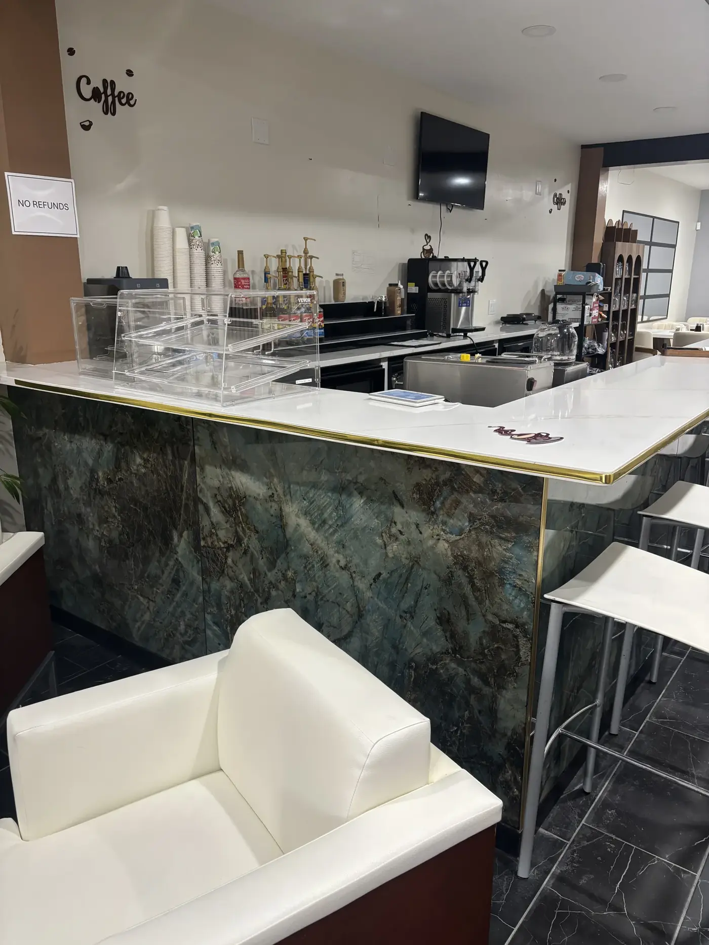 The coffee station behind Oak's marble bar